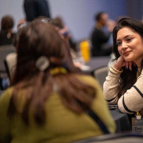 woman sitting with hand on chin